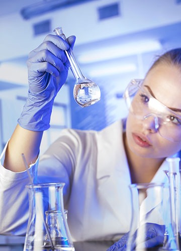 Scientist looking at flask during testing